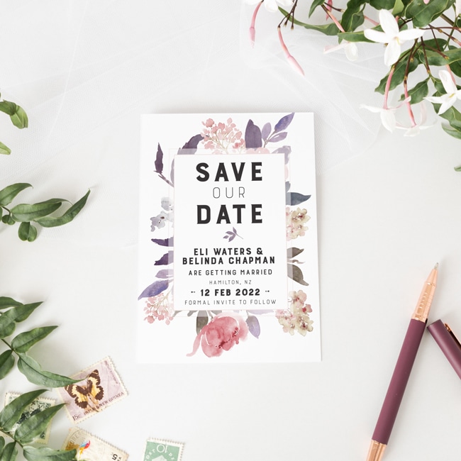 beautiful delicate pinks and purples frame this Save our Date card