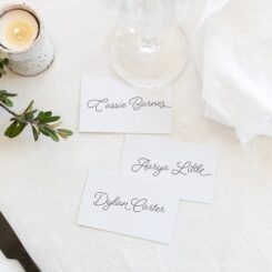 three white wedding place cards