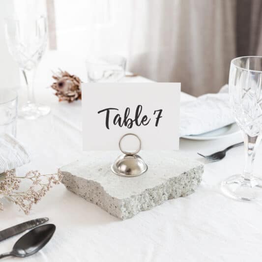 Table number eight printed in black on white card sitting on table