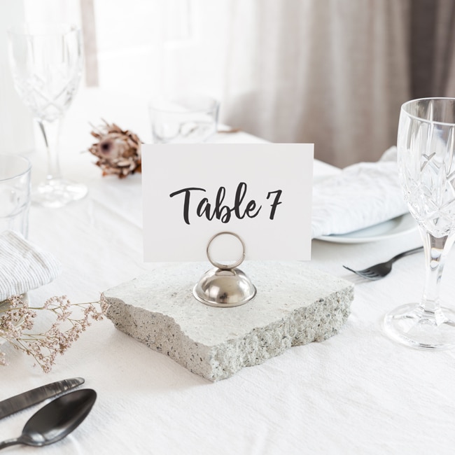Table number eight printed in black on white card sitting on table