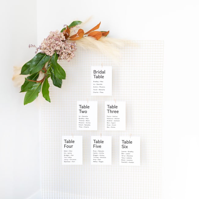 multiple small seating plan cards on wire mesh