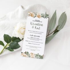 white card sitting on rose and leaves