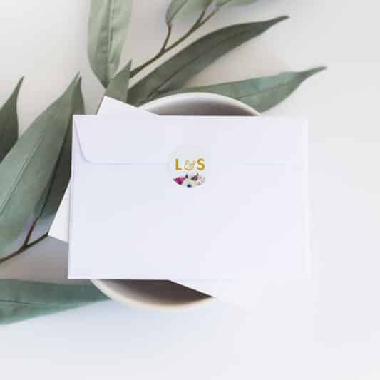 sticker with initials on back of white envelope