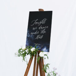wedding sign on easel with floral decoration
