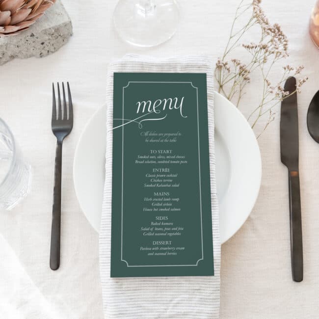 DL size wedding menu on dinner plate with linen napkin