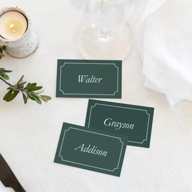 group of vintage rustic flat placecards on table next to wine glass and decorations